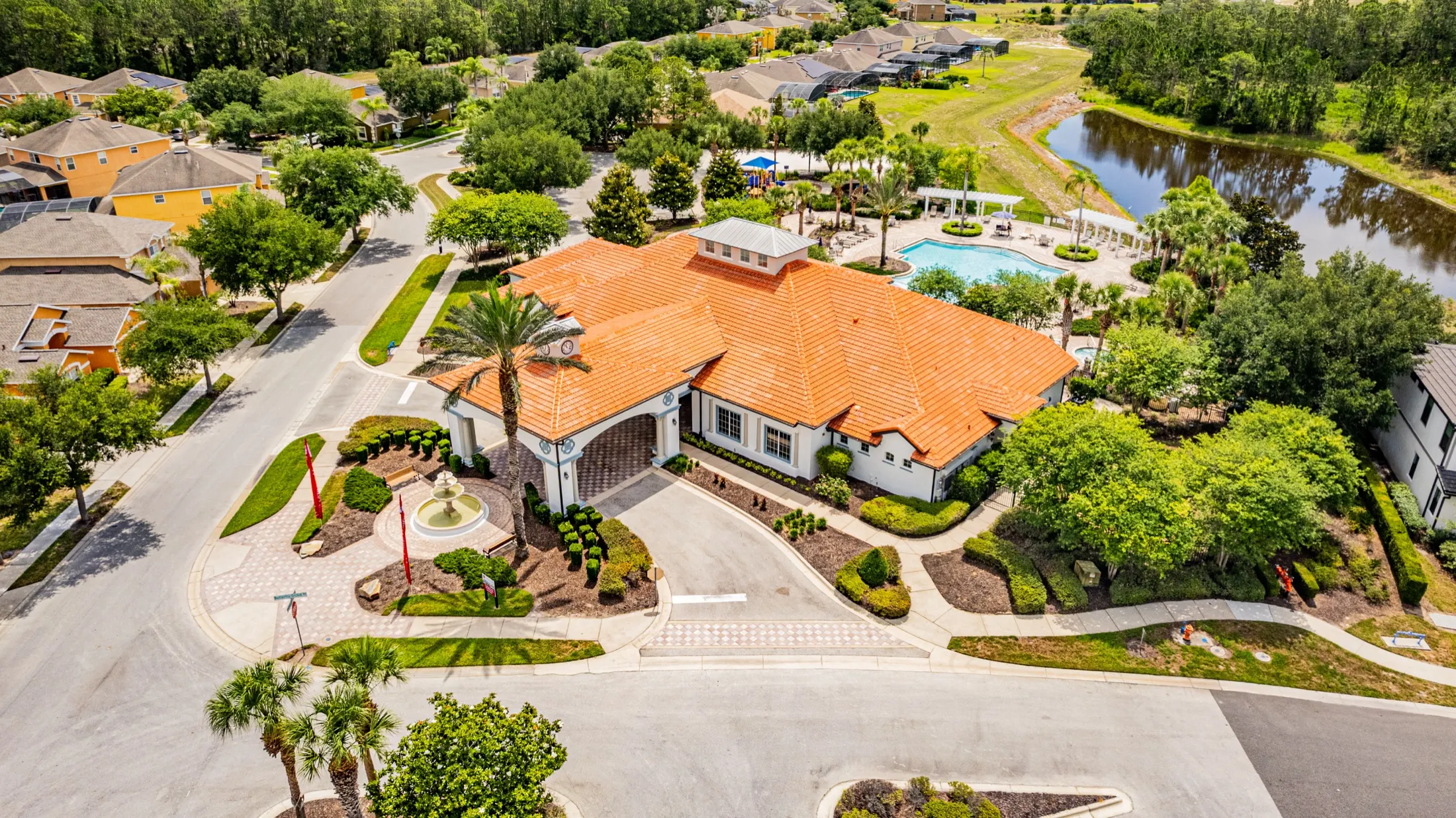 Aerial view of the Watersong Resort clubhouse, community pool and grounds — view 1
