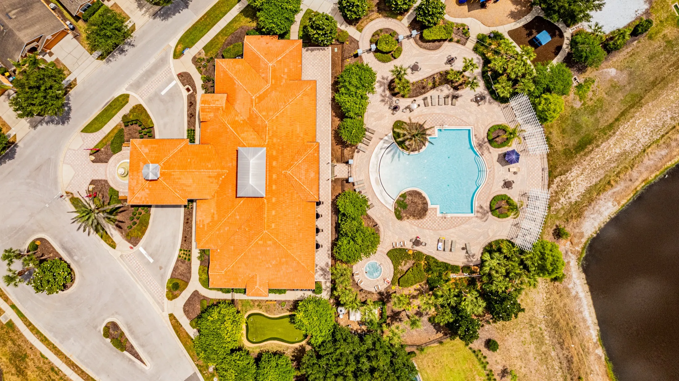 Aerial view of the Watersong Resort clubhouse, community pool and grounds — view 2