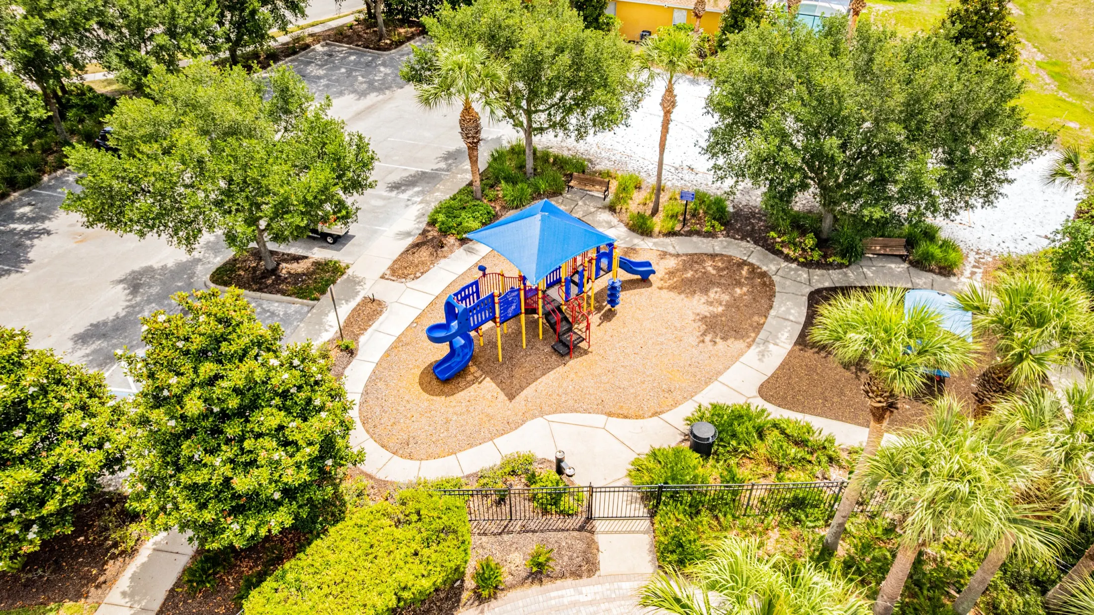 Aerial view of the Watersong Resort clubhouse, community pool and grounds — view 4
