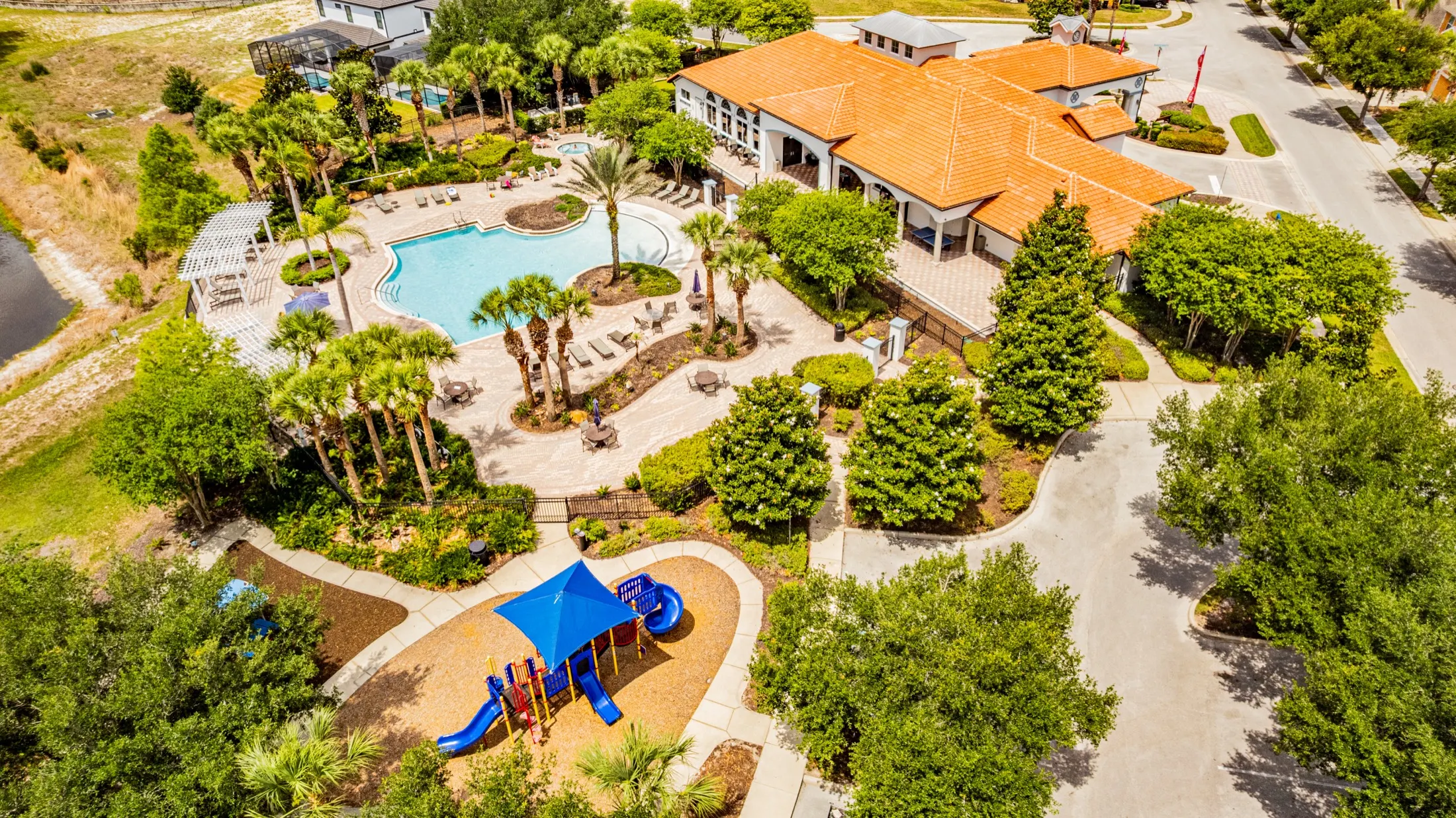 Aerial view of the Watersong Resort clubhouse, community pool and grounds — view 5