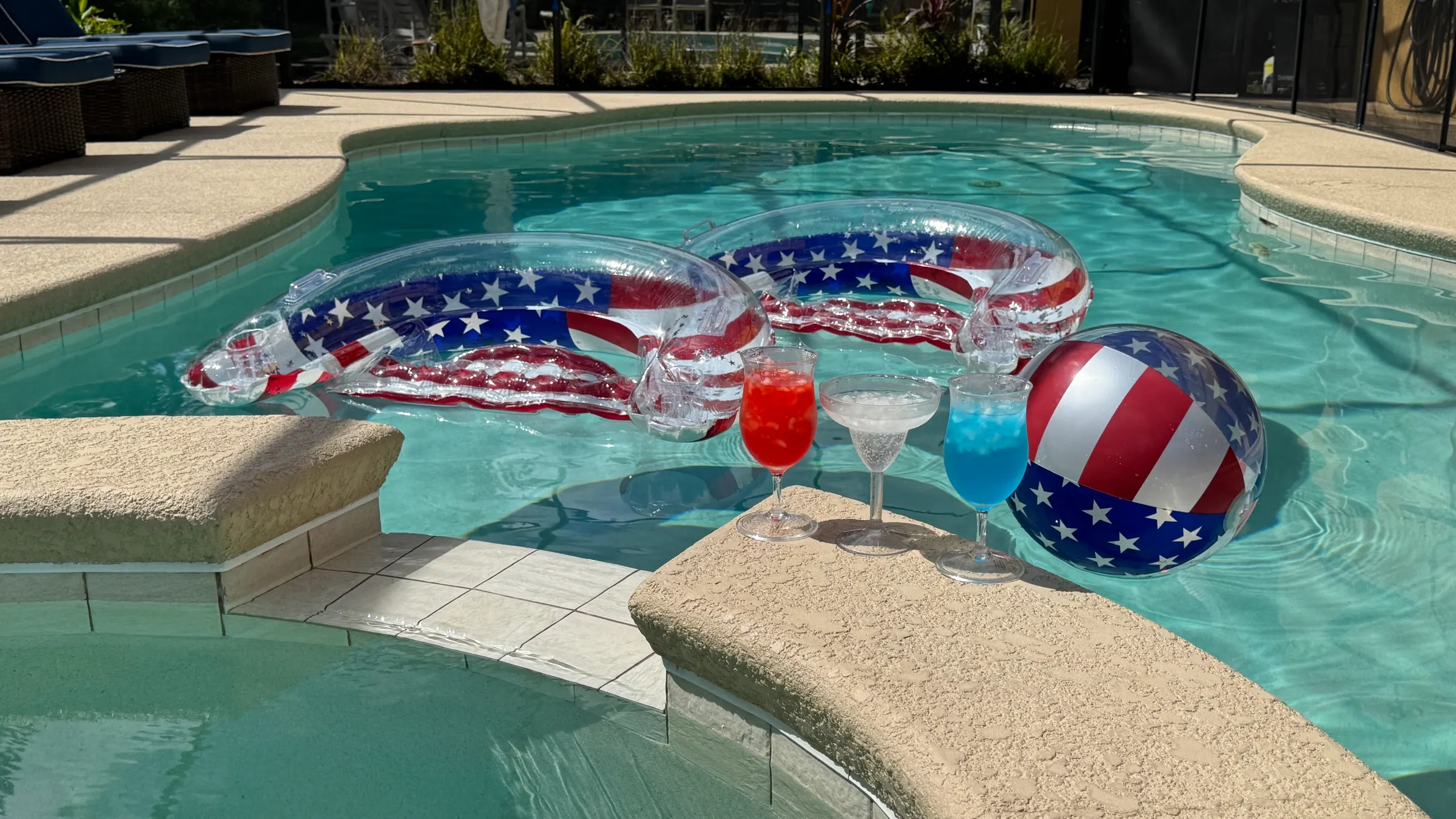 Patriotic pool floats, a beach ball and colourful cocktails by the private pool at The Watersong Residence